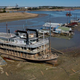 The Diamond Lady, a once-majestic riverboat, rests with smaller boats in mud at Riverside Park Marina in Martin Luther King Jr. Riverside Park along the Mississippi River on October 19, 2022 in Memphis, Tennessee.